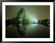 A Large Rock Formation Or Mountain On Shore Of Star Lake At Night by Raymond Gehman Limited Edition Print