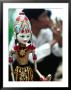 Traditional Puppet With Vendor In Background, Jakarta, Indonesia by Nicholas Pavloff Limited Edition Print