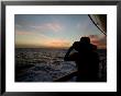 Silhouette Of A Woman On A Cruise Ship Looking At The Sunset by Todd Gipstein Limited Edition Print