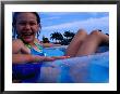Young Girl Floating In Swimming Pool In Rubber Ring, Gold Coast, Australia by Richard I'anson Limited Edition Print