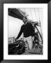 Errol Flynn With His Dog At The Helm Of A Yacht While Enjoying A Fishing Vacation by Peter Stackpole Limited Edition Print
