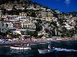 Houses Terraced Into Rugged Amalfi Coastline, Boats In Foreground, Positano, Italy by Dallas Stribley Limited Edition Print
