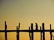 Lone Woman Walking On The U Bein Bridge At Sunset In Mandalay, Burma by Scott Stulberg Limited Edition Print