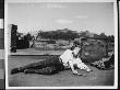 Lying On A Roof With Six-Shooter And Knife, Dressed In A Western-Style Outfit For A Costume Study by Wallace G. Levison Limited Edition Print