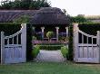 Double Gates Open - Across Formal Topiary Garden To Thatched Summer House At Lady Farm, Somerset by Clive Nichols Limited Edition Print