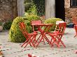 Terrace With Red Table And Chairs, Box Topiary And Tulips by Clive Nichols Limited Edition Pricing Art Print