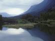 Calm Lake Reflecting Mountains, Trees And An Overcast Sky by Stephen Sharnoff Limited Edition Pricing Art Print