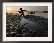 A Boy Plays On The Banks Of The River Brahmaputra In Gauhati, India, Friday, October 27, 2006 by Anupam Nath Limited Edition Print