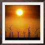 A Group Of Wind Turbines Are Silhouetted By The Setting Sun by Charlie Riedel Limited Edition Print