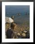 Woman's Back Covered With Mud And People Floating In The Sea In Background, Dead Sea, Israel by Eitan Simanor Limited Edition Print