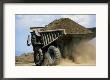 A Dump Truck Carrying Gravel Kicks Up A Cloud Of Dust by Raymond Gehman Limited Edition Print