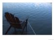 An Adirondack Chair Silhouetted By A Lake by Stacy Gold Limited Edition Print