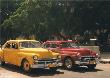 Yellow Car And Orange Taxi by Nelson Figueredo Limited Edition Print