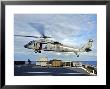 An Mh-60S Seahawk Helicopter Prepares To Deliver Ammunition by Stocktrek Images Limited Edition Pricing Art Print