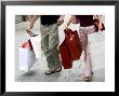 Couple Walking With Shopping Bags On Konigsallee, Dusseldorf, North Rhine Westphalia, Germany by Yadid Levy Limited Edition Print