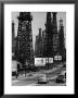 Car Traffic On Highway Next To Advertising Billboards And Oil Well Towers, Signal Hill Oil Field by Andreas Feininger Limited Edition Pricing Art Print