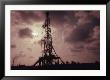 Silhouette Of An Oil Rig At Sunset by William Swartz Limited Edition Print