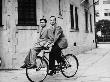 Columnist Sidney Skolsky Riding On Bob Hope's Bicycle From His Dressing Room To The Sound Stage by John Florea Limited Edition Print