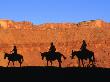Silhouette Of Mule Riders On Trail Riding Through Professor Valley, Moab, Utah, Usa by Curtis Martin Limited Edition Print