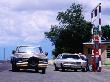 Attendant With Cars At Petrol Station In Stanley, U.S.A. by Curtis Martin Limited Edition Print