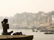 Man Stretching During His Morning Yoga Exercises Overlooking The Holy River Ganges by Gavin Gough Limited Edition Print