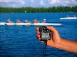 Hand Holding Stopwatch With Crew Team In Background by Mark Segal Limited Edition Pricing Art Print