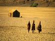 Himba Women Walking In The Desert, Near Purros, Namibia by Roger De La Harpe Limited Edition Pricing Art Print