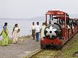 People Walk Next To Miniature Train Near Elephanta Island by Mick Elmore Limited Edition Pricing Art Print