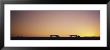 Silhouette Of Two Trucks Moving On A Highway, Interstate 5, California, Usa by Panoramic Images Limited Edition Pricing Art Print