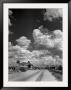 Cumulus Clouds Billowing Over Texaco Gas Station Along A Stretch Of Highway Us 66 by Andreas Feininger Limited Edition Print