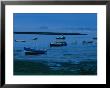 Small Fishing Boats Line The Shore At The North End Of Lindisfarne by Sisse Brimberg Limited Edition Pricing Art Print