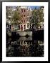 Tall Traditional Style Houses Reflected In The Water Of A Canal, Amsterdam, The Netherlands by Richard Nebesky Limited Edition Print