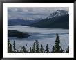 Snow-Capped Moutains Rise Above A Frozen Waterway On Kodiak Island by George F. Mobley Limited Edition Print