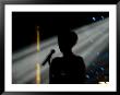 Female Singer And Microphone Silhouetted With Stage Lights by Todd Gipstein Limited Edition Print