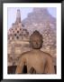 Large Buddha Image With Stupas In Background, Borobudur, Central Java, Indonesia by Bernard Napthine Limited Edition Print
