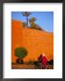 Veiled Woman Bicycling Below Red City Walls, Marrakech, Morocco by John & Lisa Merrill Limited Edition Print