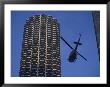 A Helicopter Flies Between Skyscrapers by Joel Sartore Limited Edition Pricing Art Print