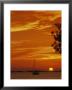 A Sailboat Is Silhouetted By A Brilliant Orange Sunset by Nicole Duplaix Limited Edition Print