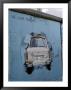 A Trabant Car Painted On A Section Of The Berlin Wall Near Potsdamer Platz, Mitte, Berlin, Germany by Richard Nebesky Limited Edition Print
