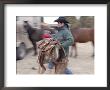 A Male Rancher Lifts A Saddle At The Nebraska National Forest by Joel Sartore Limited Edition Print