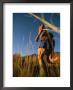 A Man Runs Through Tall Grass Near Mt. Elden by John Burcham Limited Edition Pricing Art Print
