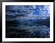 Early Morning Boating In Reflected Sea Of Clouds, Lake Mcdonald, Glacier National Park, Montana, Us by Gareth Mccormack Limited Edition Print