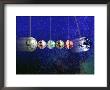Money Globes Swinging On Pendulum With The Earth by Paul Katz Limited Edition Print