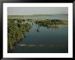 An Antelope Splashes Across The Futi River Flood Plain In The Maputo Elephant Reserve by Chris Johns Limited Edition Pricing Art Print