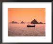 Boat On Bay Waters With Islets In Background, Halong Bay, Vietnam by Manfred Gottschalk Limited Edition Print
