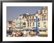 Group Of Elderly People Sitting On Seafront In The Restort Town Of Mers Les Bains, Picardy, France by David Hughes Limited Edition Pricing Art Print