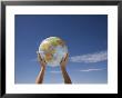 Woman's Hands Holding Globe, Death Valley National Park, California by Angelo Cavalli Limited Edition Print