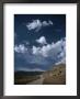 Dirt Road To Ranch Through Desert Hills Against A Blue Cloudy Sky by Todd Gipstein Limited Edition Print
