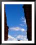 Climbers Scale The Sharks Fin, A Rock Formation In Monument Basin by Bill Hatcher Limited Edition Print