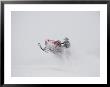 A Snowmobiler Jumps From A Hill On A Snowy Day by Taylor S. Kennedy Limited Edition Print